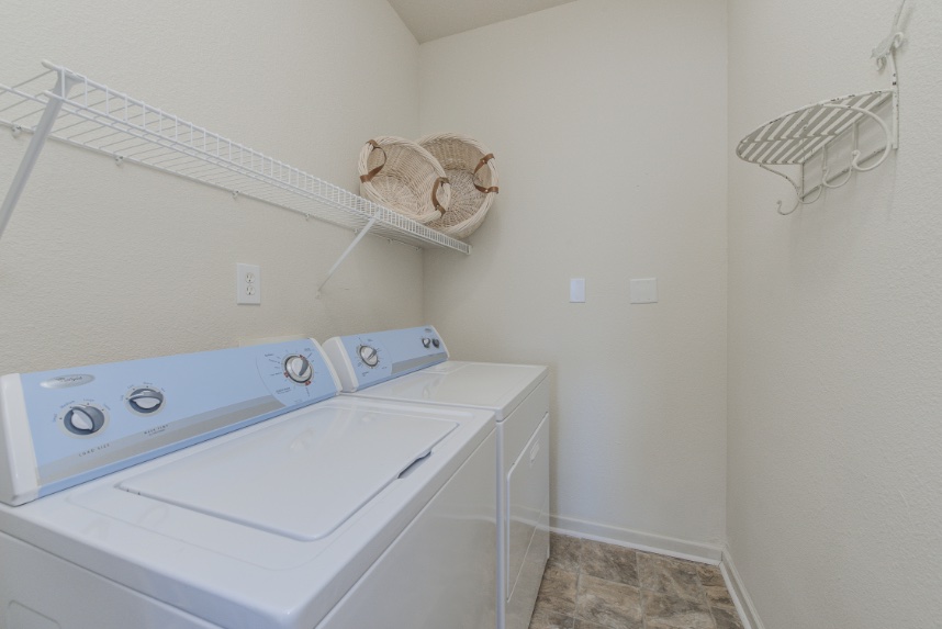 Laundry room with storage space in Carmel.